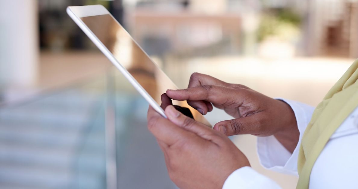 Someone holding a tablet