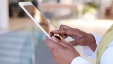 Someone holding a tablet