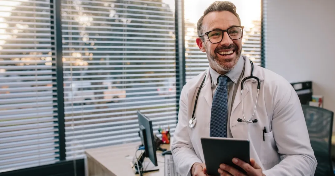 Physician holding a stethoscope and a tablet computer Physician holding a stethoscope and a tablet computer