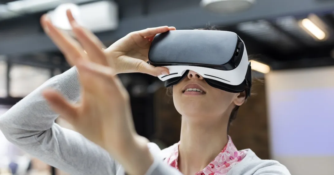 Woman looking into virtual reality glasses Woman looking into virtual reality glasses