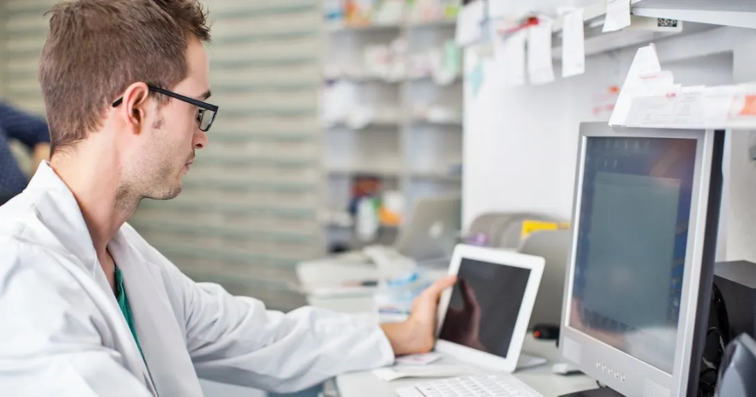 Healthcare professional looking at data on a screen