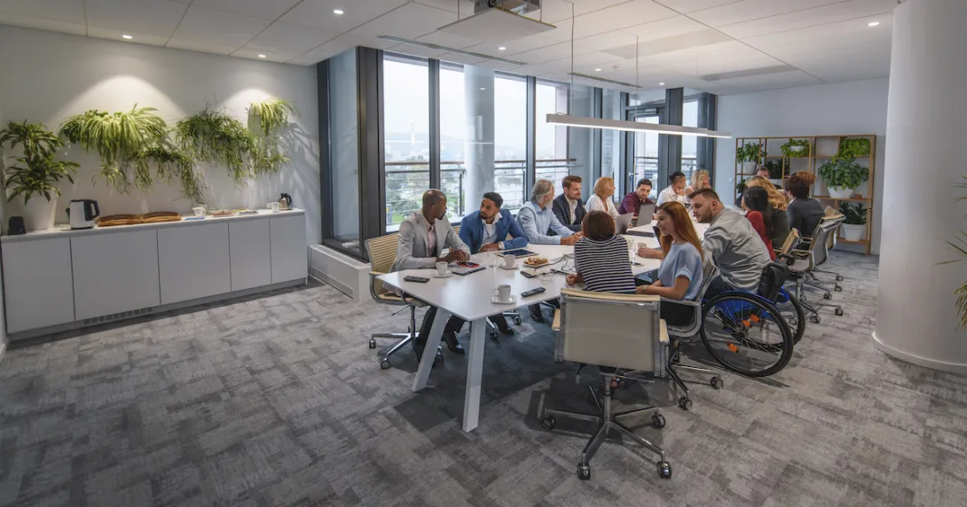 People sitting around a table in a conference room
People sitting around a table in a conference room