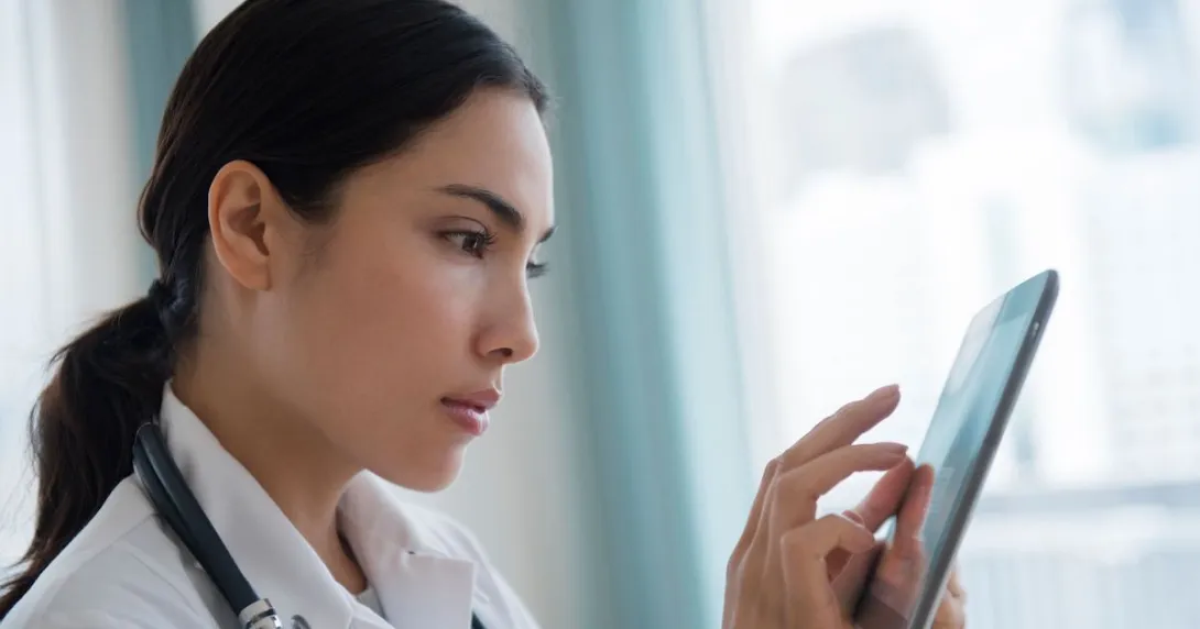 Healthcare provider looking at a tablet