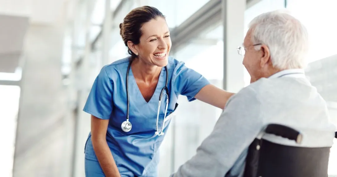 Person in a wheelchair next to a nurse Person in a wheelchair next to a nurse
