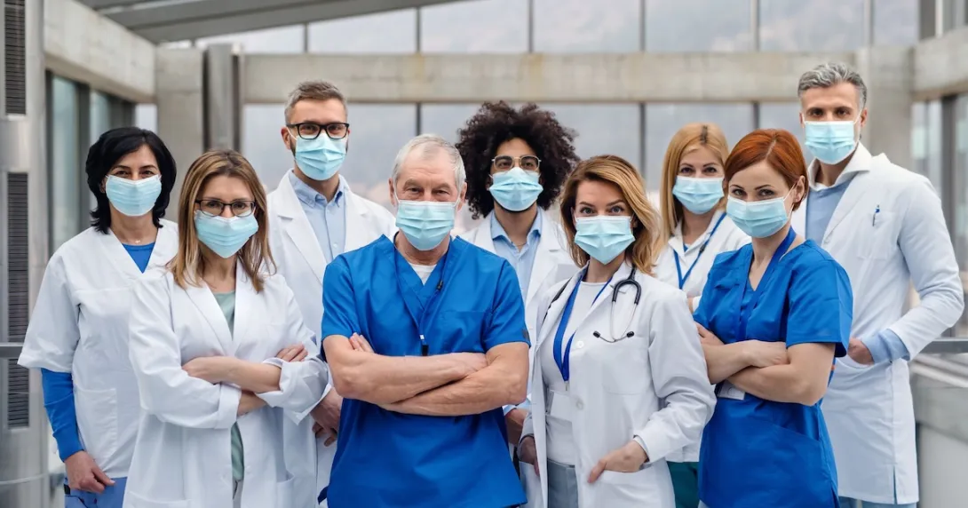 Healthcare providers standing together in a hospital setting Healthcare providers standing together in a hospital setting