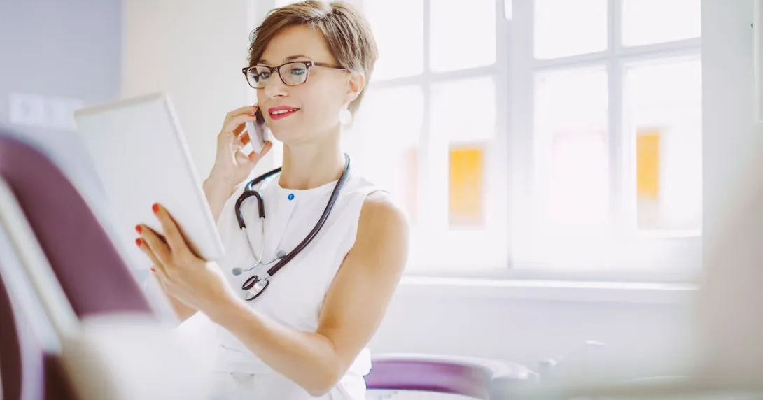 Healthcare provider looking at a tablet while wearing a white shirt and a stethoscope around their neck
Healthcare provider looking at a tablet while wearing a white shirt and a stethoscope around their neck