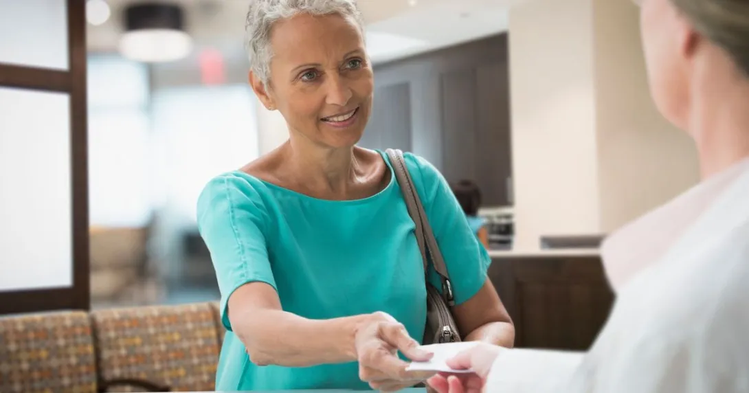 Person giving a healthcare provider a piece of paper Person giving a healthcare provider a piece of paper