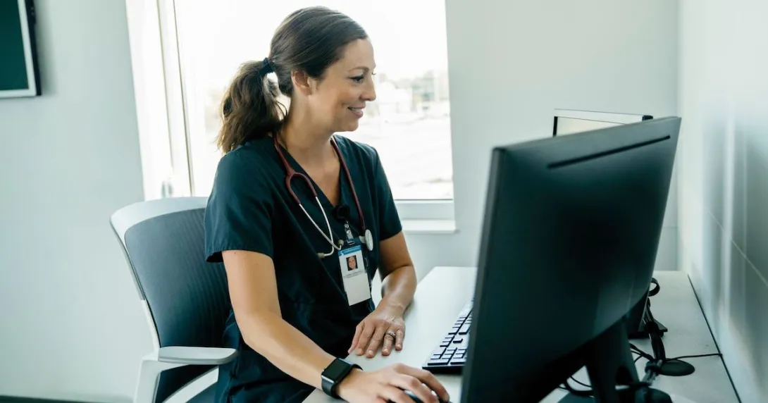 A healthcare provider with scrubs on and a stethoscope around their neck sitting at a desk while looking at a computer
A healthcare provider with scrubs on and a stethoscope around their neck sitting at a desk while looking at a computer