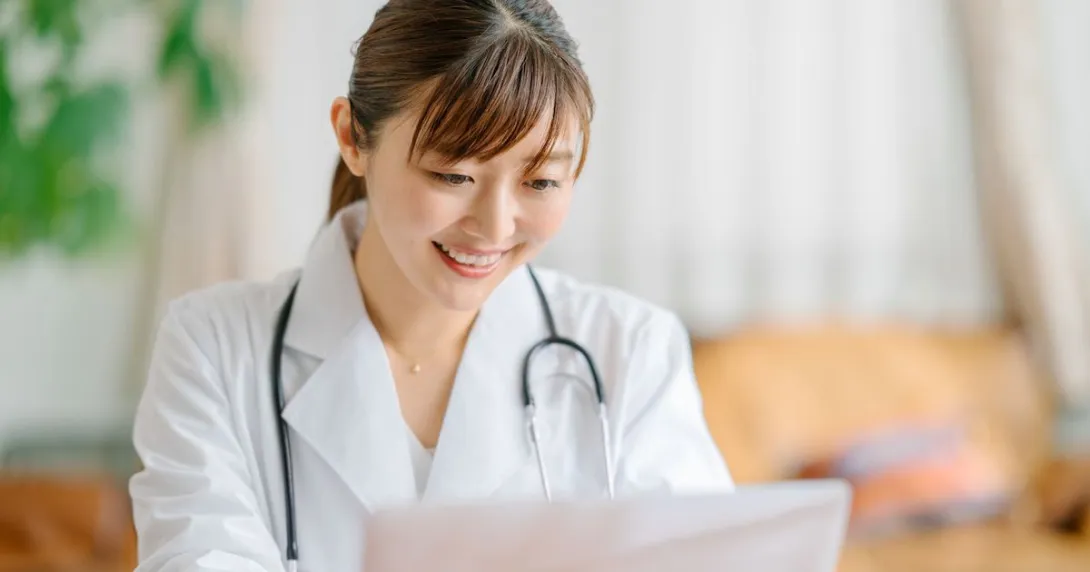 A doctor using a laptop computer A doctor using a laptop computer