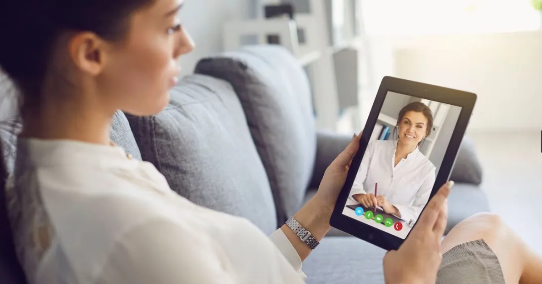 A person talking to a provider via a video chat on a tablet.
A person talking to a provider via a video chat on a tablet.