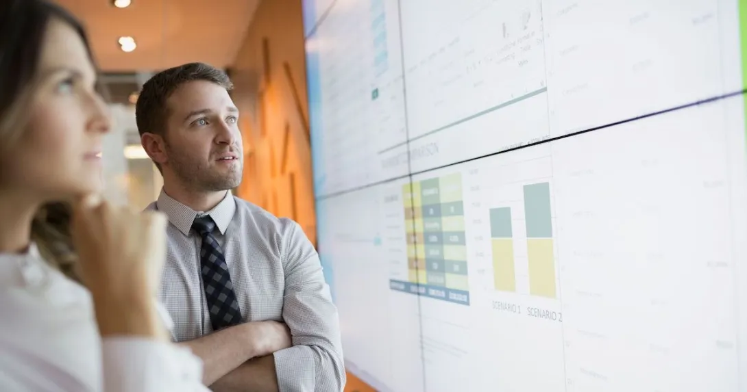 Businesspeople looking at financial charts.