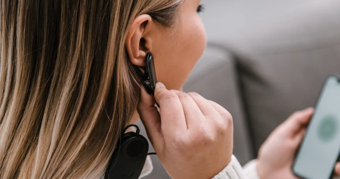 A close up of a woman using Meru's biofeedback device and app. A close up of a woman using Meru's biofeedback device and app.