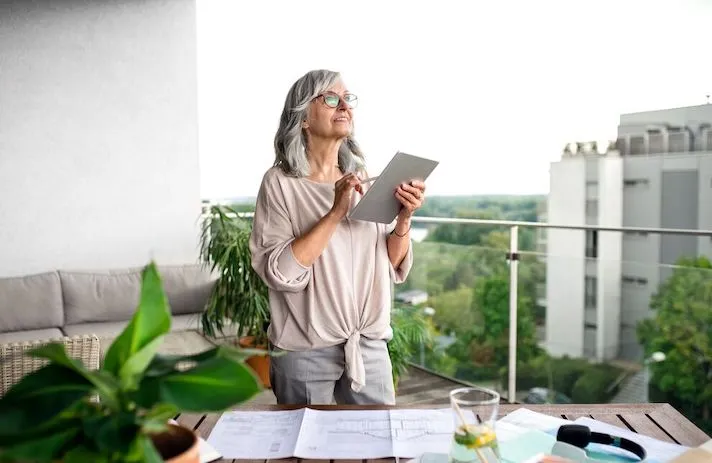 An older woman using a tablet.