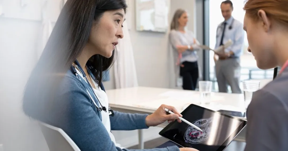 A doctor explaining findings from a brain scan to a patient A doctor explaining findings from a brain scan to a patient